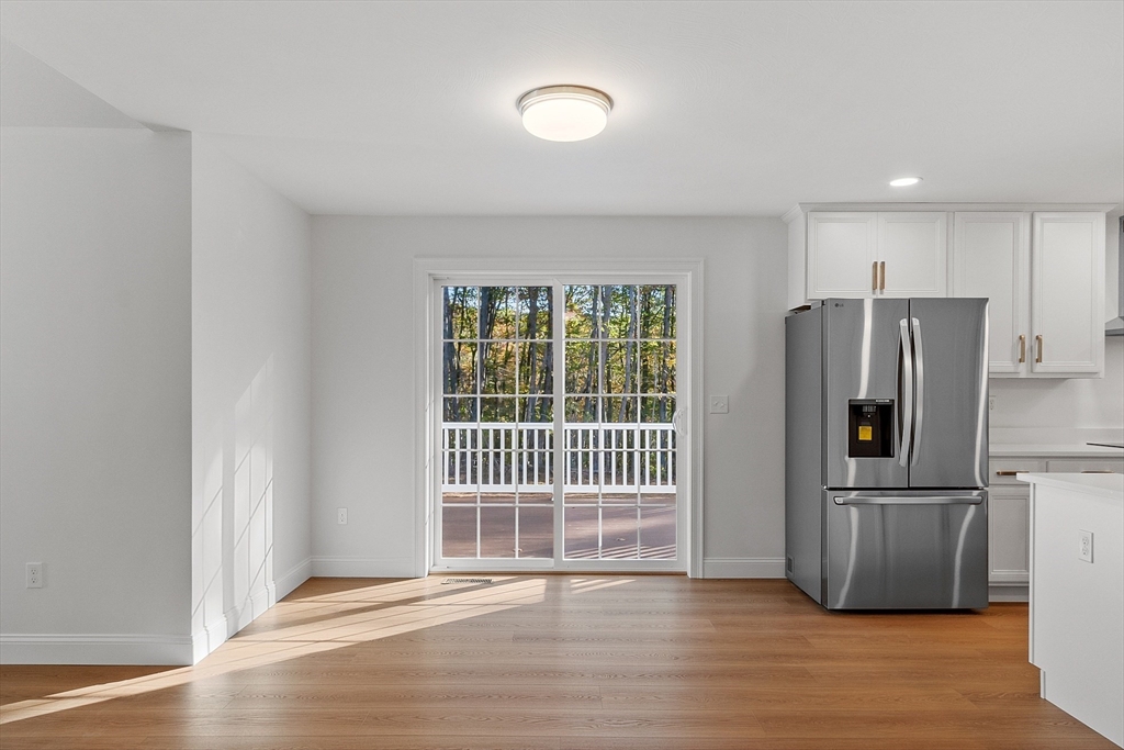 0 Gardner Road, Unit APPLEWOOD Templeton, MA 01468 - Photo 26 of 36 a view of a kitchen with wooden floor electronic appliances and windows