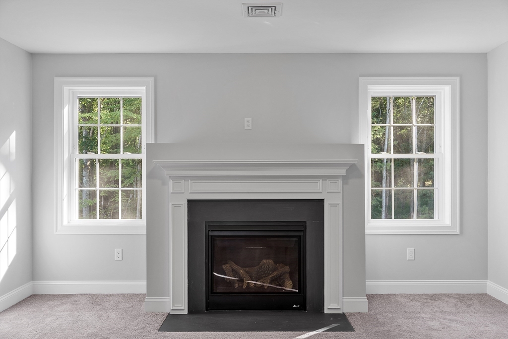 0 Gardner Road, Unit APPLEWOOD Templeton, MA 01468 - Photo 29 of 36 a living room with a fireplace and a window