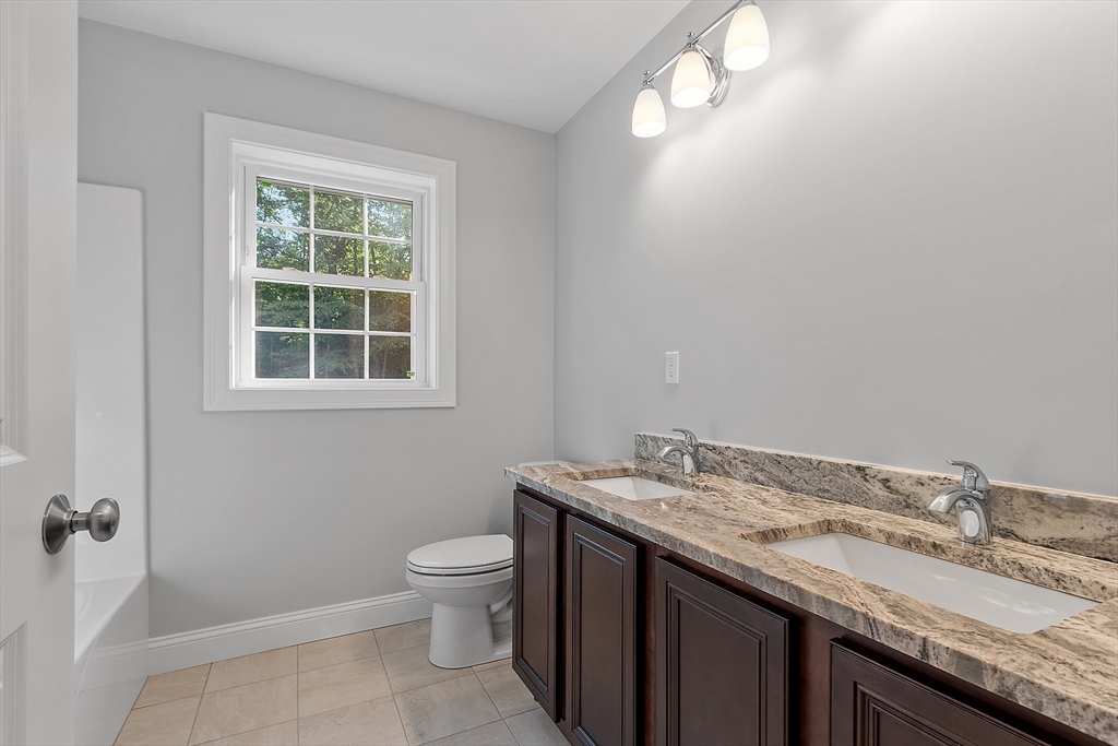 0 Gardner Road, Unit APPLEWOOD Templeton, MA 01468 - Photo 30 of 36 a bathroom with a granite countertop sink a toilet and a window