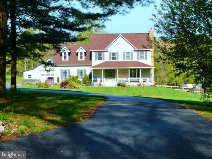 a front view of a house with a garden and plants