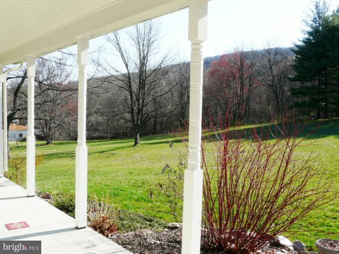 7224 Gilardi Road Boonsboro, MD 21713 - Photo 2 of 30 a view of a garden with a tree in the background