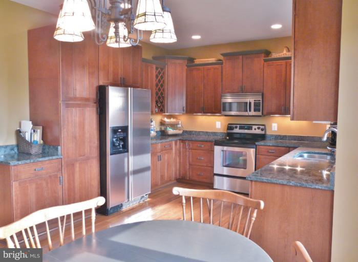 7224 Gilardi Road Boonsboro, MD 21713 - Photo 15 of 30 a kitchen with stainless steel appliances granite countertop a refrigerator a stove top oven a sink and dishwasher