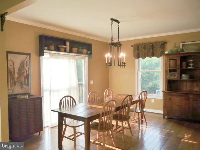 7224 Gilardi Road Boonsboro, MD 21713 - Photo 6 of 30 a view of a dining room with furniture window and wooden floor