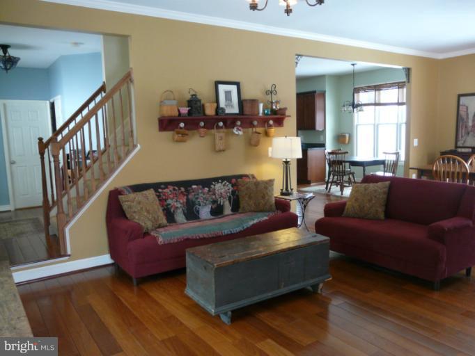 7224 Gilardi Road Boonsboro, MD 21713 - Photo 8 of 30 a living room with furniture and a wooden floor