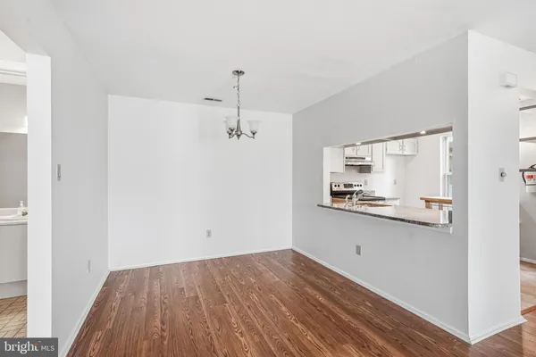 a view of a kitchen with a sink and wooden floor