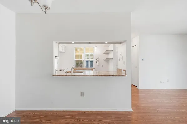 a view of kitchen with wooden floor and window