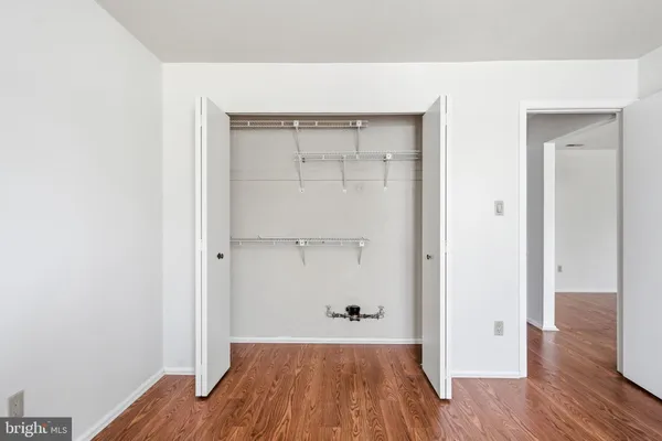 a view of a room with wooden floor and closet