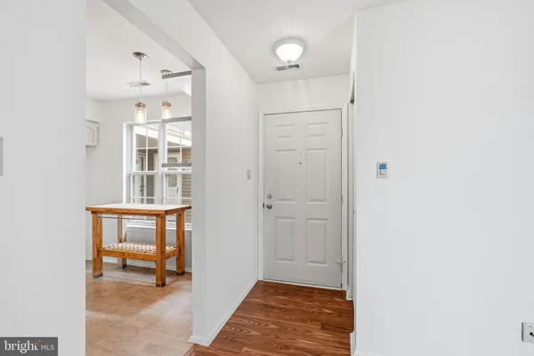 a view of an entryway with wooden floor