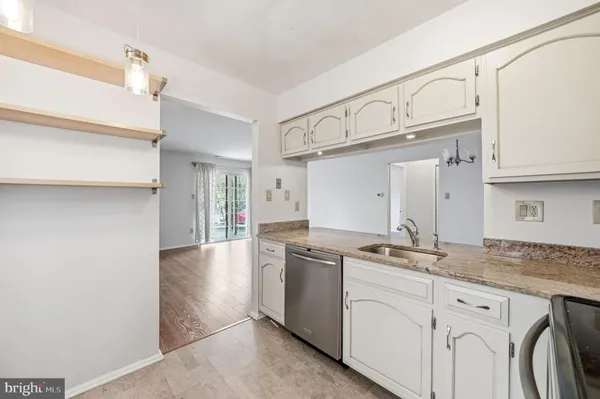 a kitchen with granite countertop a sink and cabinets