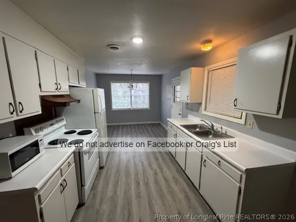 a kitchen with a stove a sink and a refrigerator