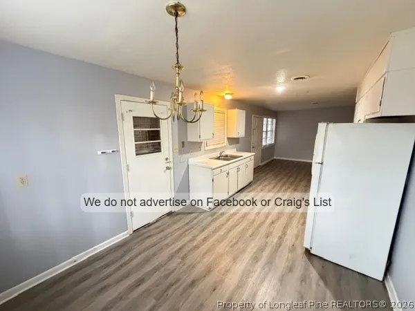 a view of a kitchen with a sink and microwave