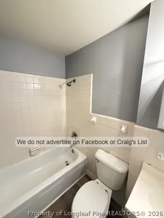 a white bath tub sitting next to a white toilet