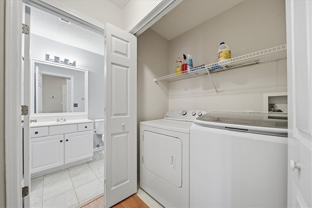 101 Grand Oak Circle Pendleton, SC 29670 - Photo 23 of 40 Functional laundry facilities with shelving for tidiness, adjacent to a well-appointed bathroom.