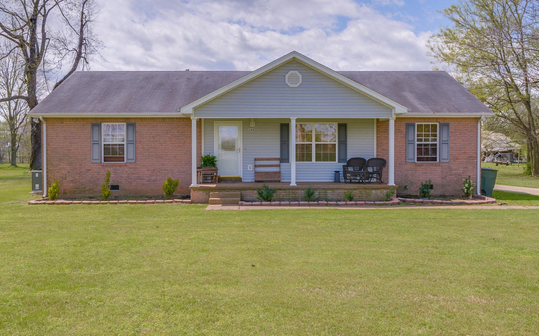 a front view of house with yard and seating space