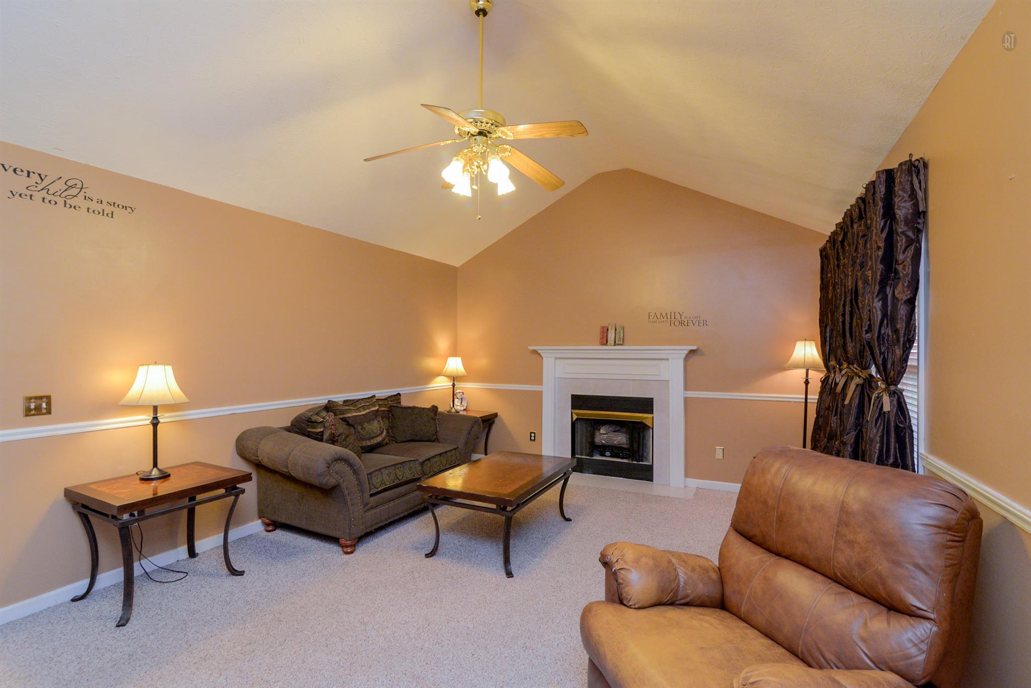 244 T G T Road Portland, TN 37148 - Photo 2 of 10 a living room with furniture a fireplace and a lamp