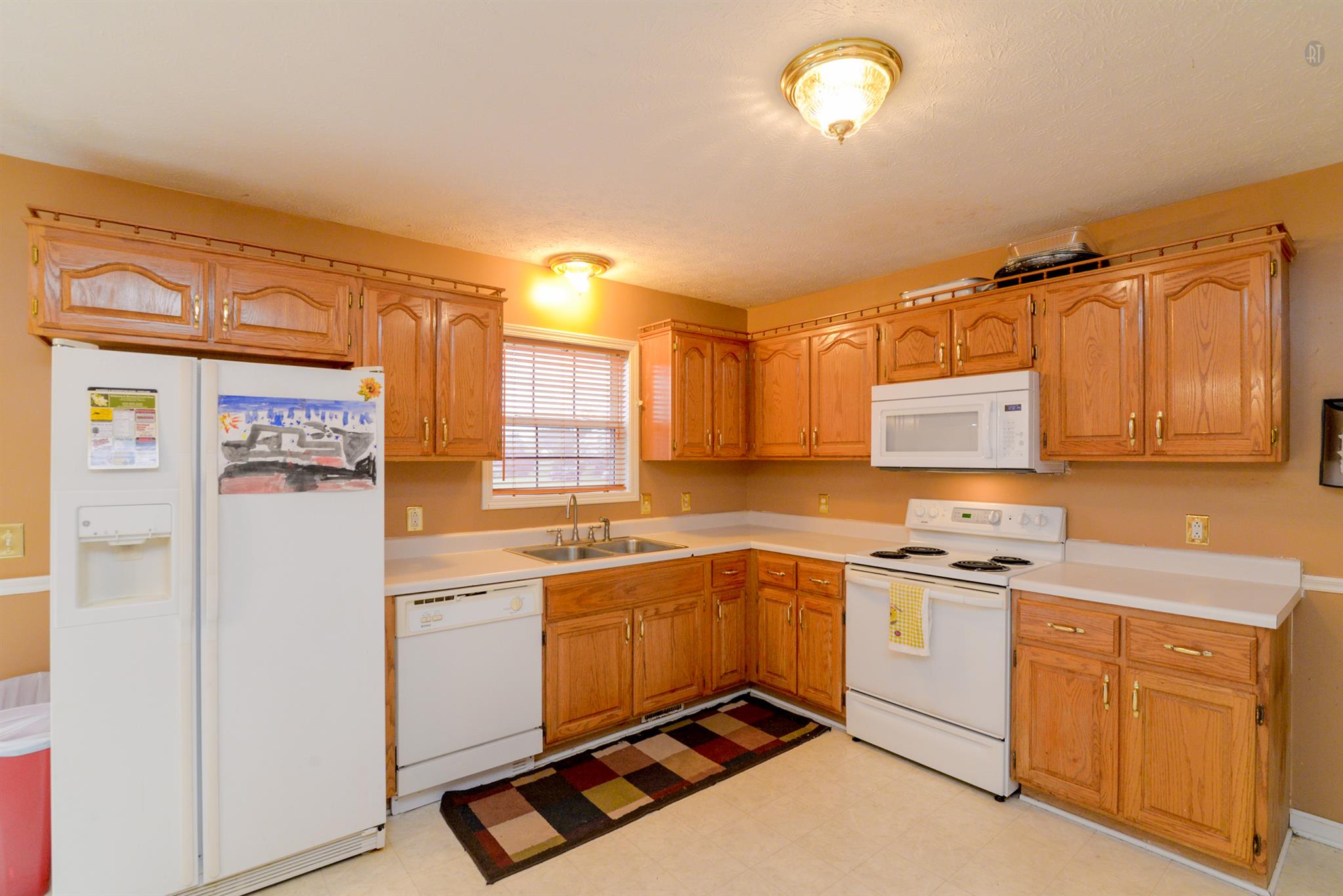 244 T G T Road Portland, TN 37148 - Photo 4 of 10 a kitchen with a sink window and cabinets