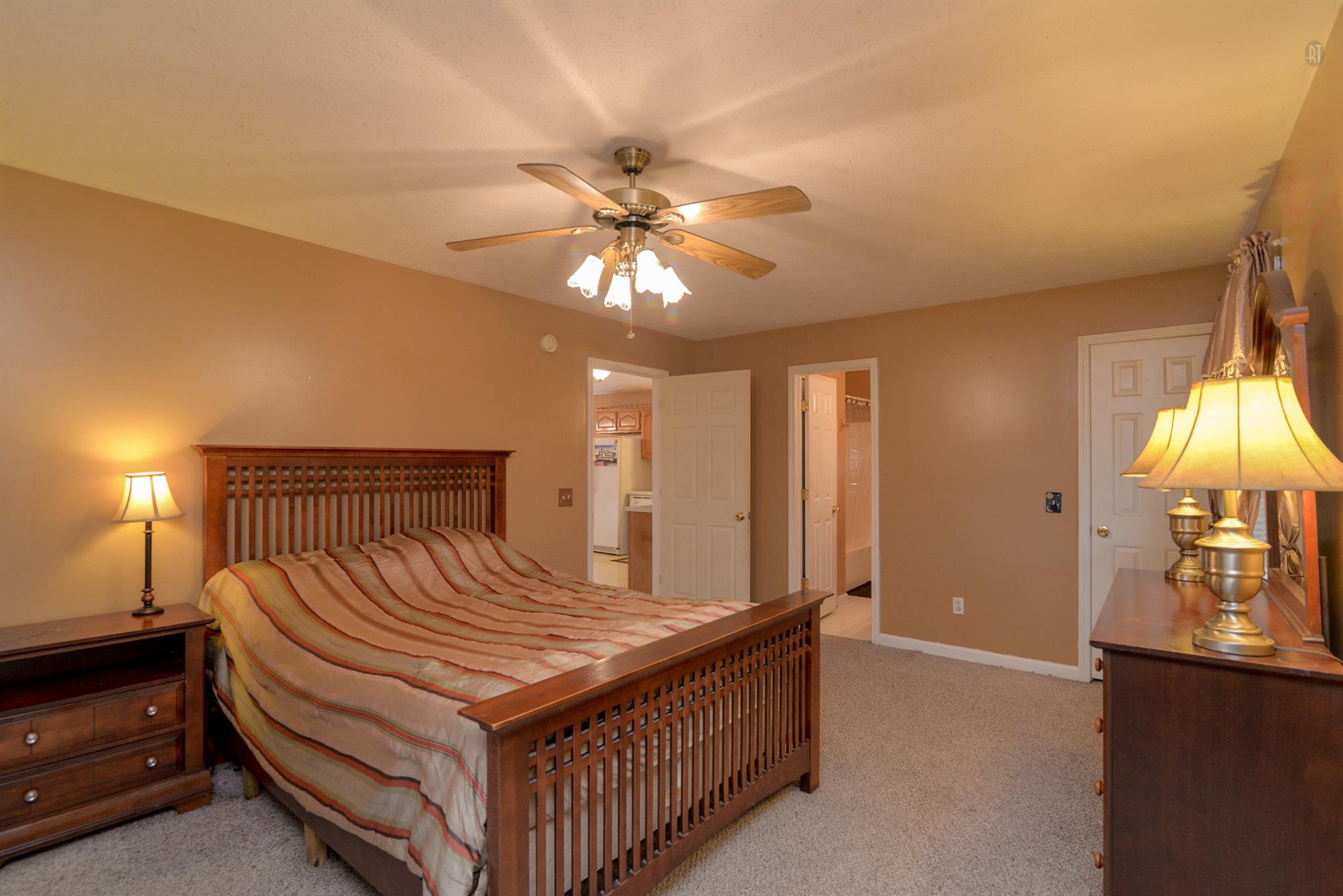 244 T G T Road Portland, TN 37148 - Photo 5 of 10 a bedroom with a bed and a chandelier