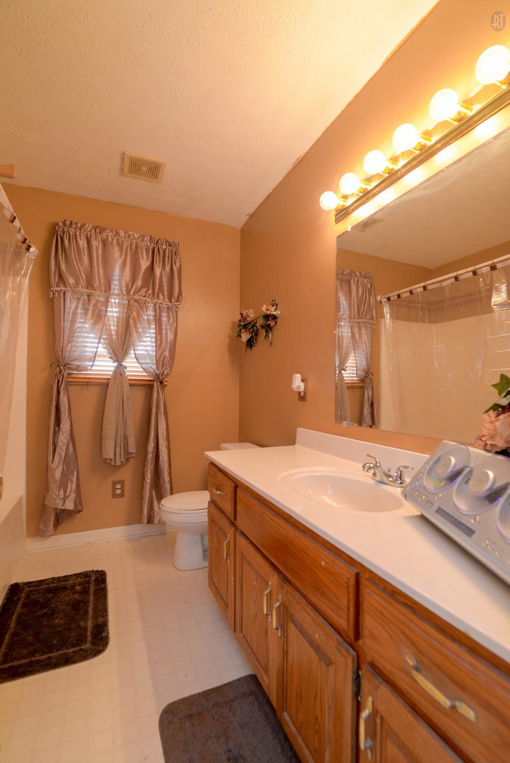 244 T G T Road Portland, TN 37148 - Photo 6 of 10 a bathroom with a sink and a mirror