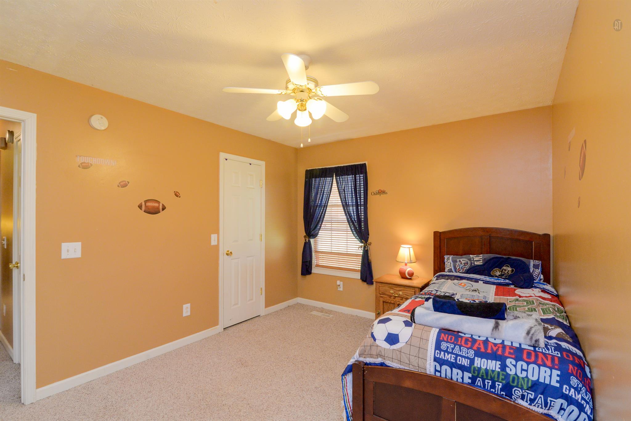244 T G T Road Portland, TN 37148 - Photo 8 of 10 a bedroom with a bed and a chandelier