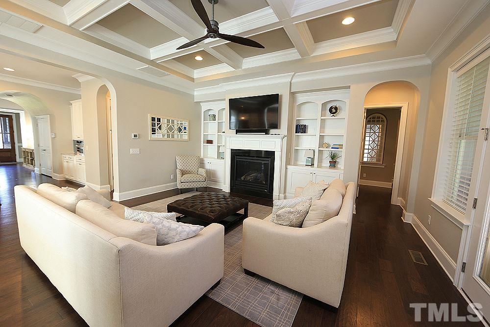 7600 Scarlet Court Raleigh, NC 27614 - Photo 13 of 30 Coffered ceilings, built-in-bookshelves and a gas log fireplace make this room very cozy.