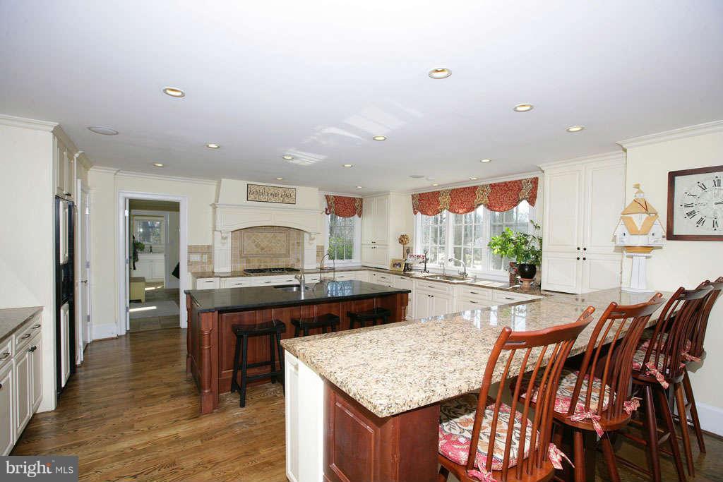 10820 Lockland Road Potomac, MD 20854 - Photo 12 of 30 a view of a kitchen with kitchen island a table and chairs in it