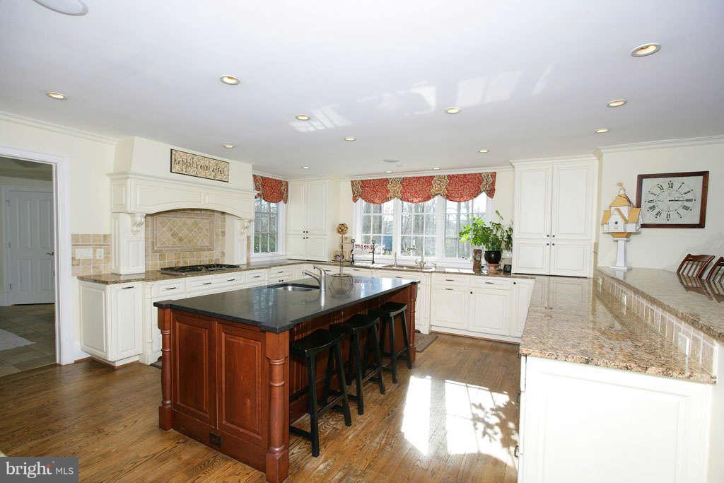 10820 Lockland Road Potomac, MD 20854 - Photo 13 of 30 a kitchen with stainless steel appliances granite countertop a stove and a sink