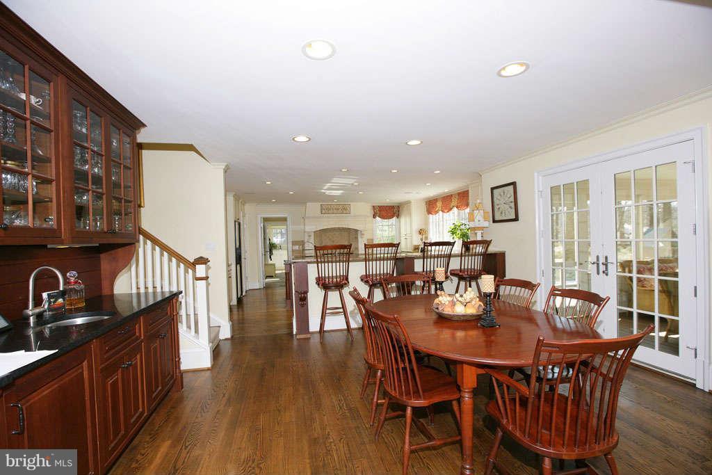 10820 Lockland Road Potomac, MD 20854 - Photo 19 of 30 a dining room with furniture a kitchen view and wooden floor