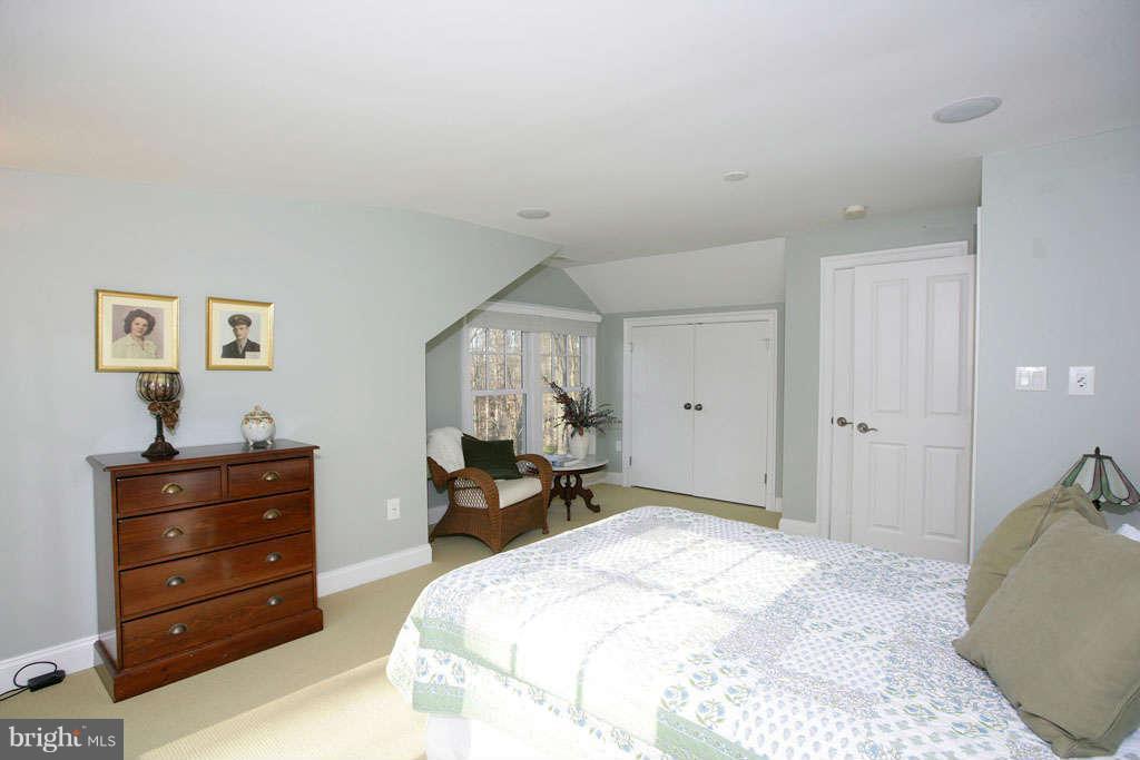 10820 Lockland Road Potomac, MD 20854 - Photo 24 of 30 a spacious bedroom with a bed and a dresser