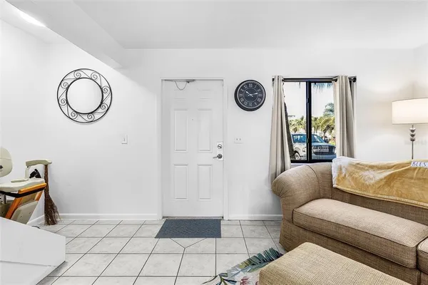 a living room with a couch and a mirror