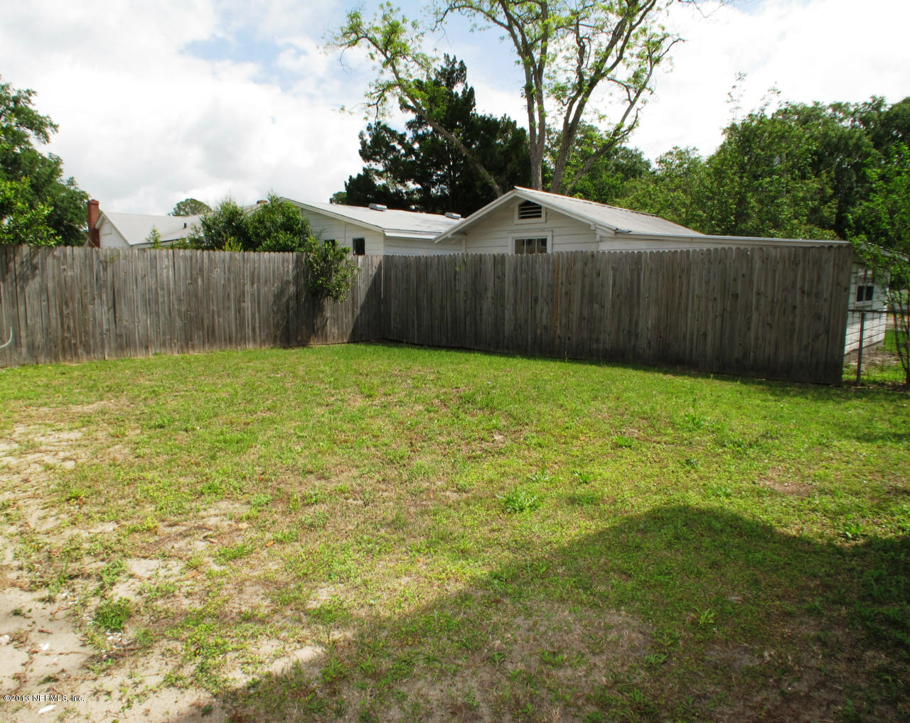 5109 Birkenhead Road Jacksonville, FL 32210 - Photo 16 of 20 a view of a backyard with wooden fence