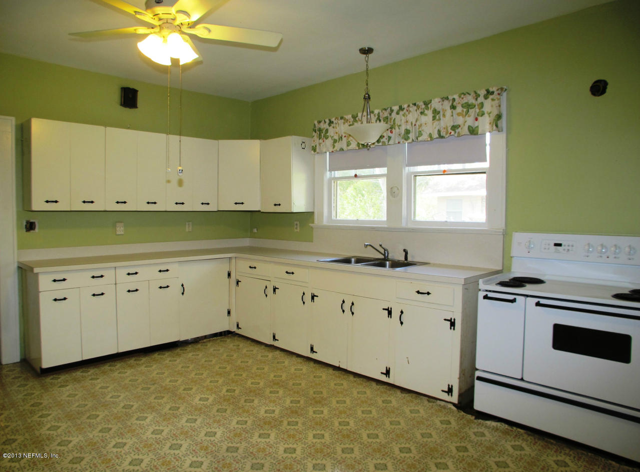 5109 Birkenhead Road Jacksonville, FL 32210 - Photo 9 of 20 a kitchen with granite countertop white cabinets white stove a sink and dishwasher