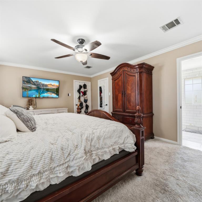 785 Tweedy Road Valley Mills, TX 76689 - Photo 19 of 40 Spacious room featuring plush carpeting, a ceiling fan with integrated lighting, and crown molding