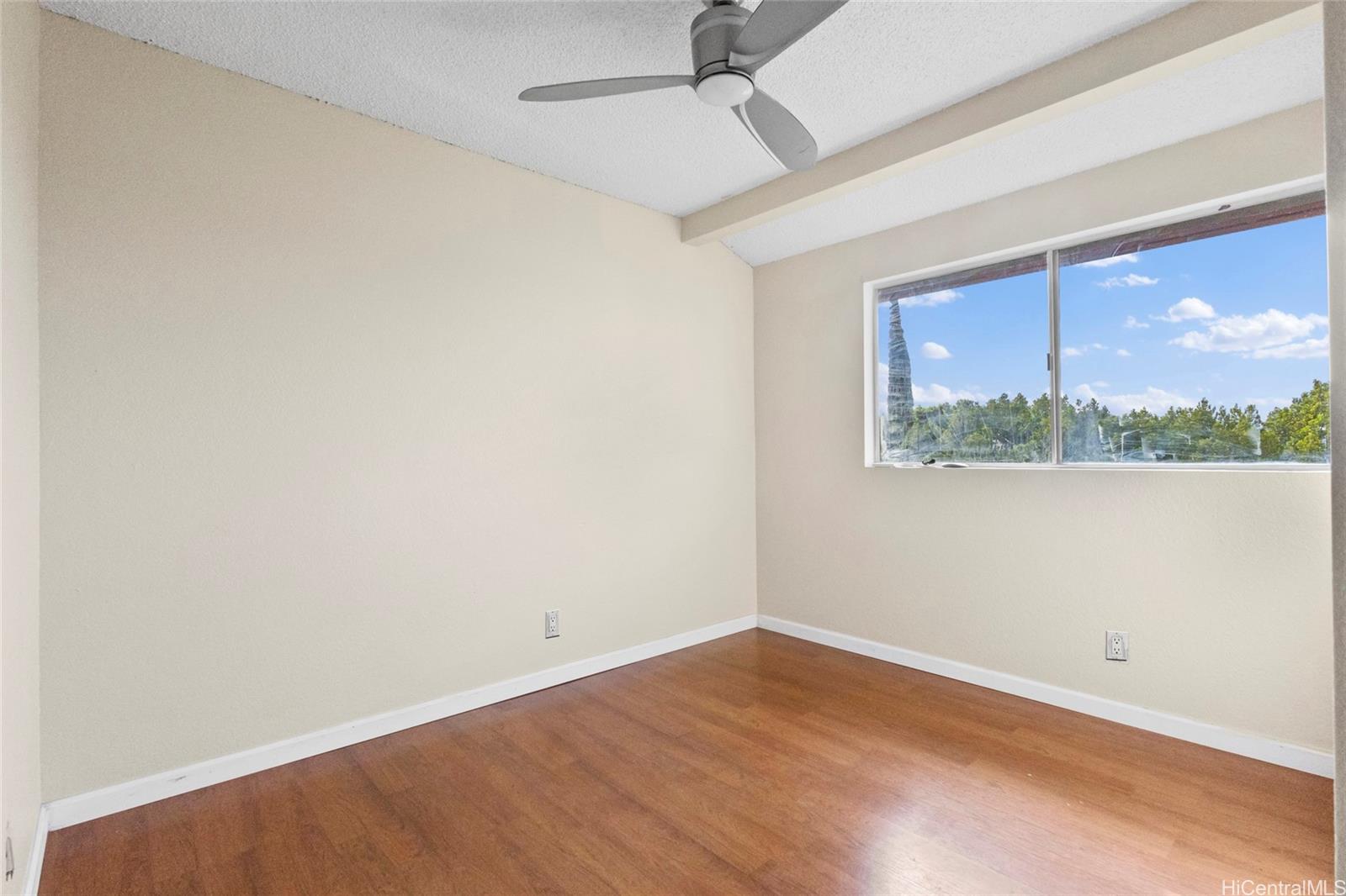 92-1226 Makakilo Drive, Unit 6 Kapolei, HI 96707 - Photo 13 of 15 an empty room with a window and wooden floor