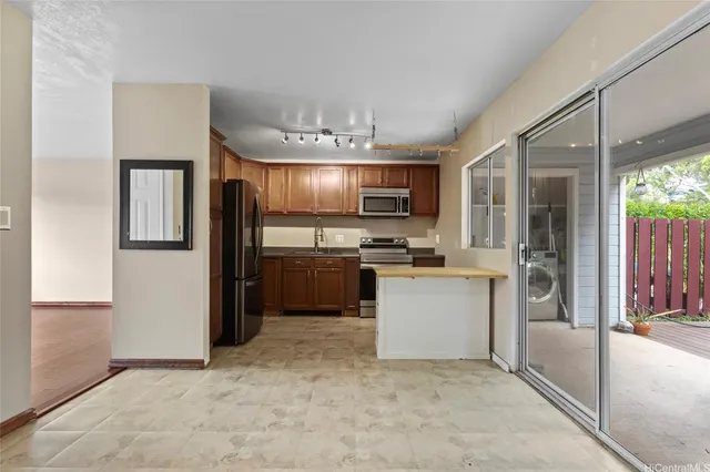 a kitchen with a refrigerator and a sink