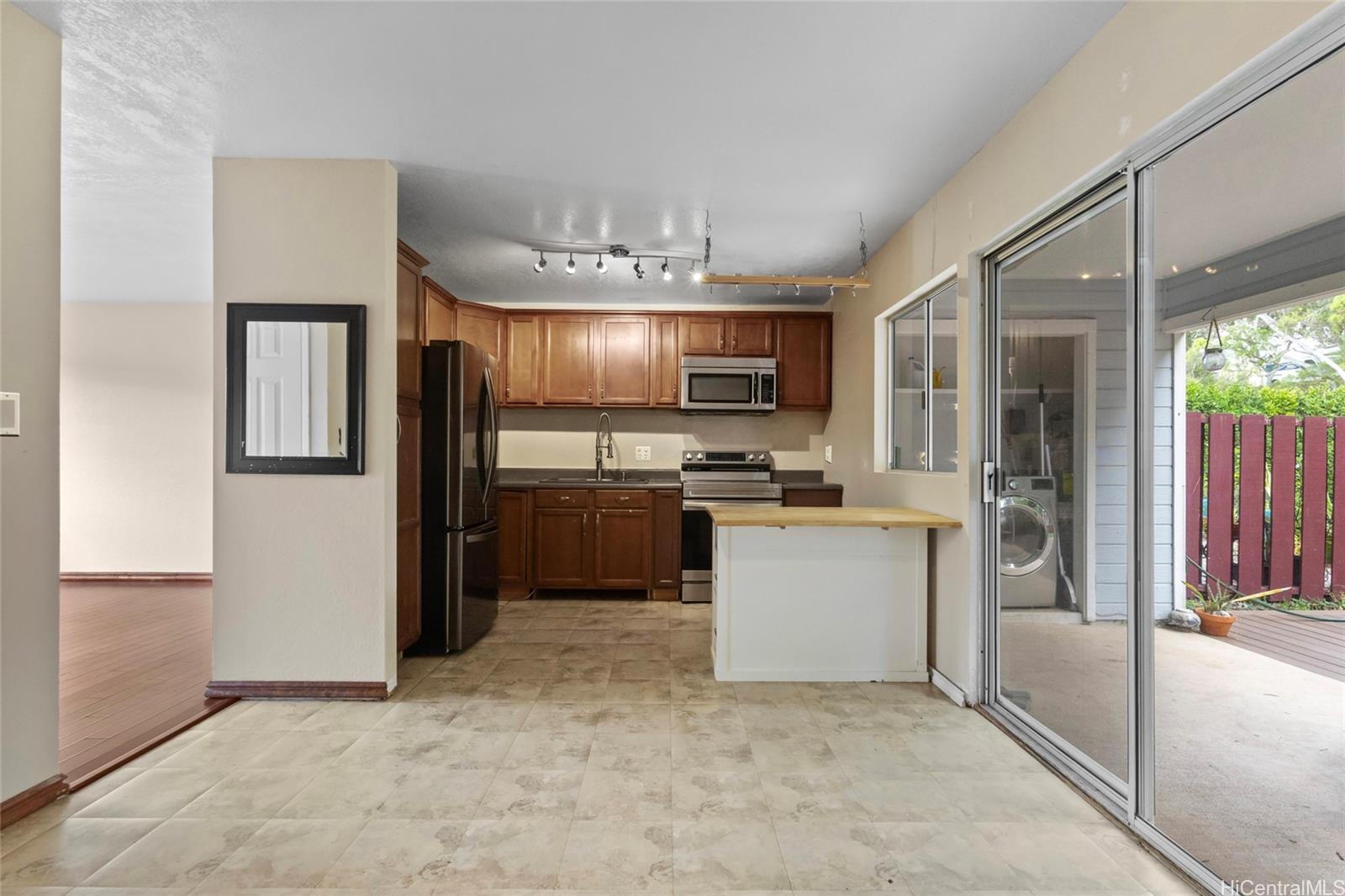 92-1226 Makakilo Drive, Unit 6 Kapolei, HI 96707 - Photo 3 of 15 a kitchen with a refrigerator and a sink