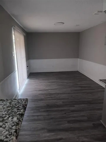 a view of wooden floor and windows in a room