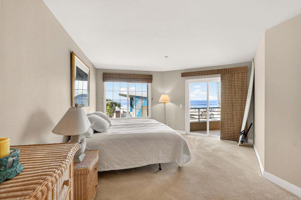 400 The Strand North, Unit 7 Oceanside, CA 92054 - Photo 16 of 35 a bedroom with a bed and a large window
