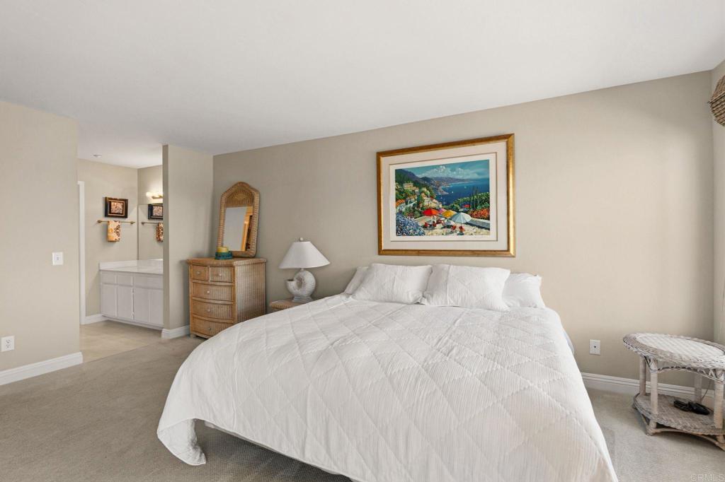 400 The Strand North, Unit 7 Oceanside, CA 92054 - Photo 21 of 35 a bedroom with a bed and a painting on the wall