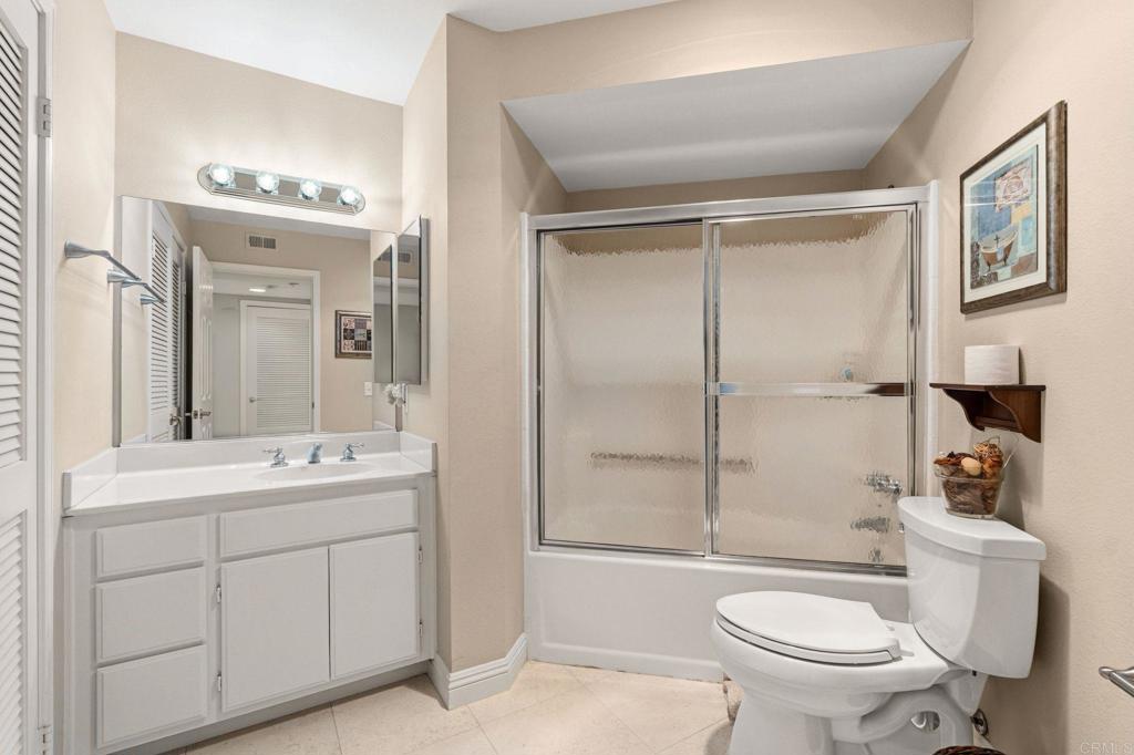 400 The Strand North, Unit 7 Oceanside, CA 92054 - Photo 25 of 35 a bathroom with a sink toilet vanity and shower