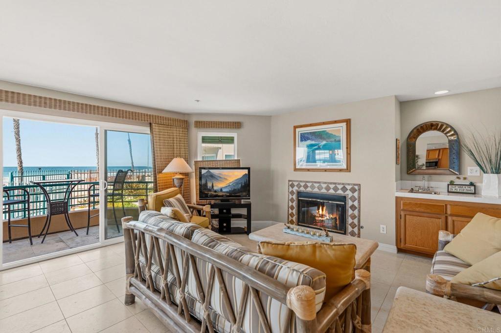 400 The Strand North, Unit 7 Oceanside, CA 92054 - Photo 5 of 35 a living room with furniture fireplace and flat screen tv