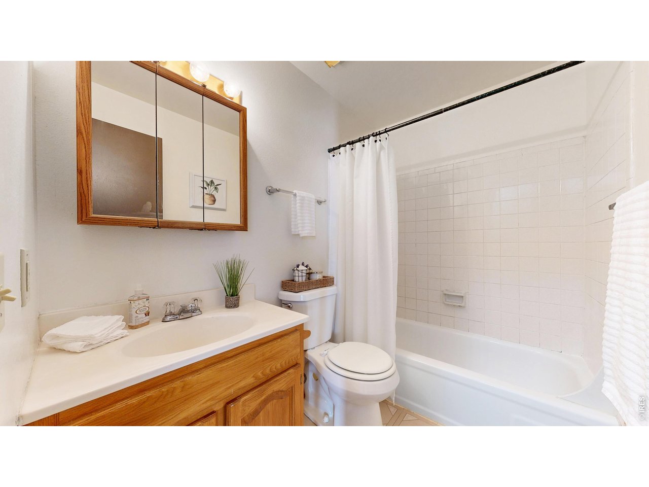 1705 Heatheridge Road, Unit G302 Fort Collins, CO 80526 - Photo 12 of 31 a bathroom with a sink toilet a mirror and shower