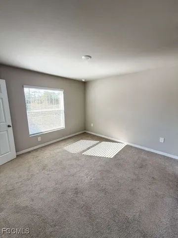 an empty room with a empty space and windows