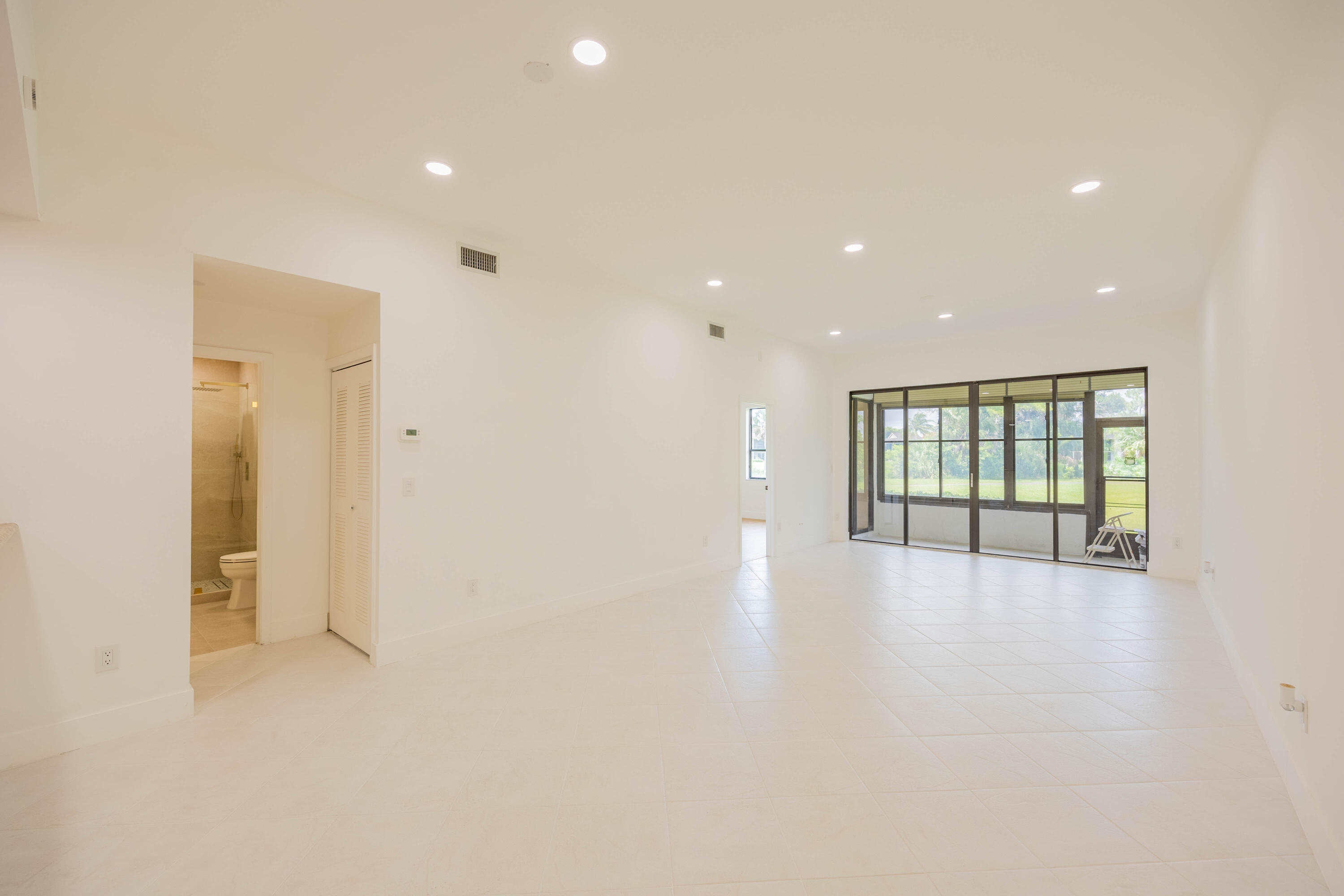7520 La Paz Boulevard, Unit 104 Boca Raton, FL 33433 - Photo 17 of 56 a view of an empty room with glass door