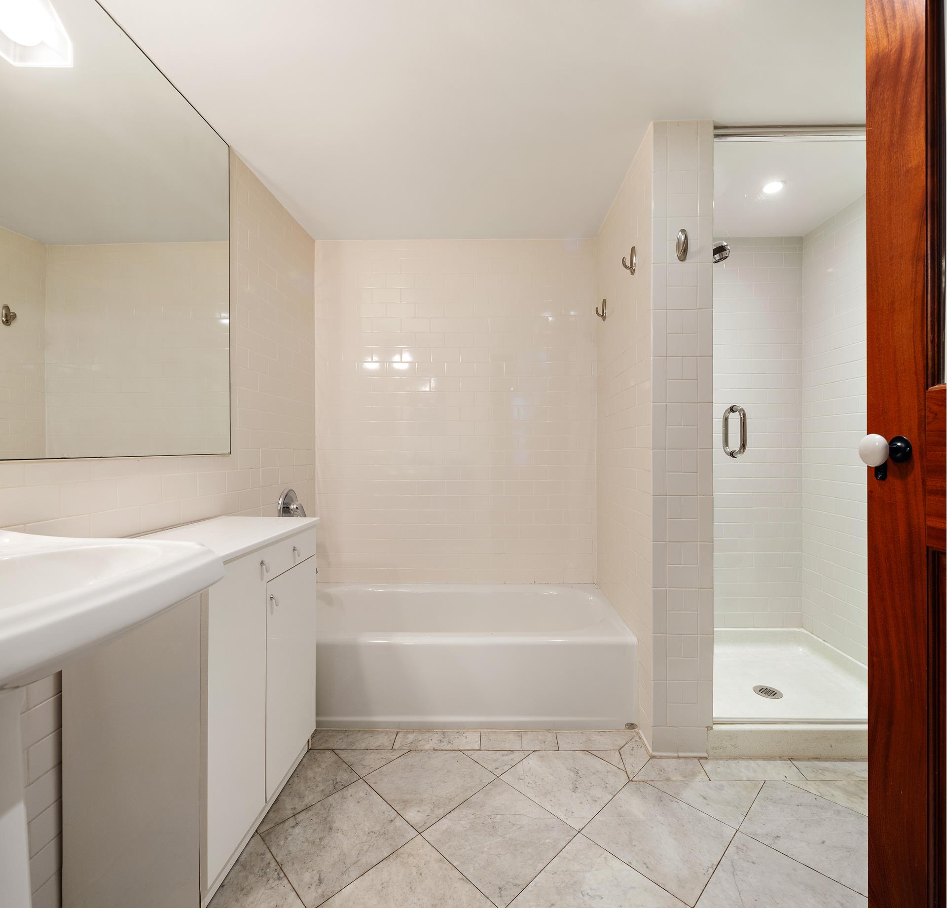 46 Mercer Street, Unit 4W Manhattan, NY 10013 - Photo 16 of 19 a bathroom with a bathtub and shower