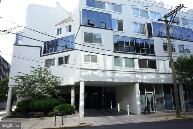 a front view of a building with a garden