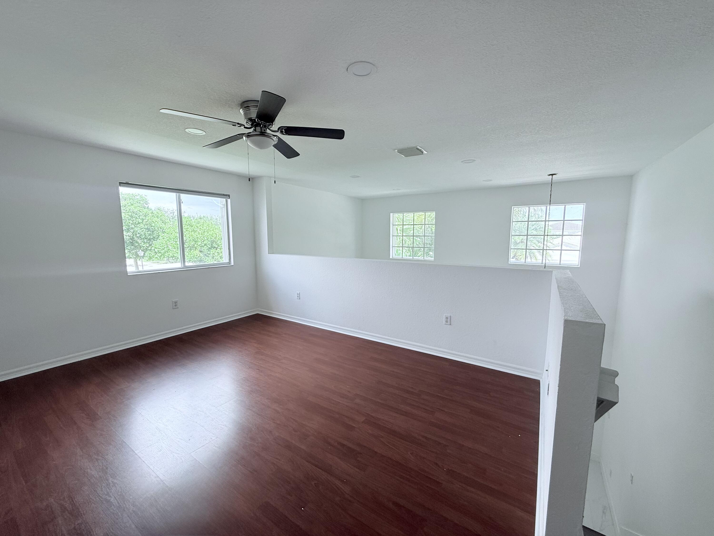 4534 Southwest 127th Terrace Miramar, FL 33027 - Photo 29 of 45 an empty room with wooden floor and windows