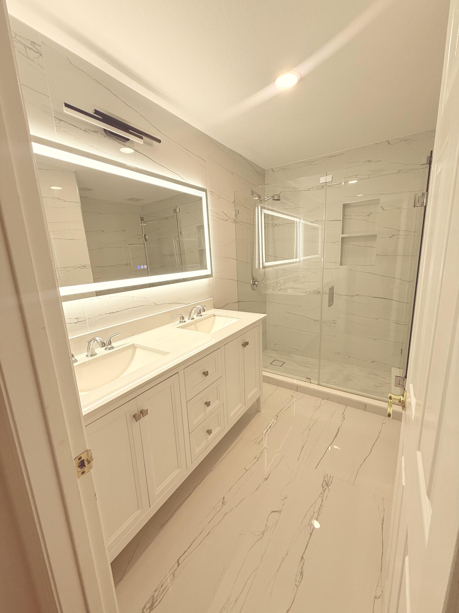 4534 Southwest 127th Terrace Miramar, FL 33027 - Photo 32 of 45 a bathroom with a double vanity sink a mirror and a shower