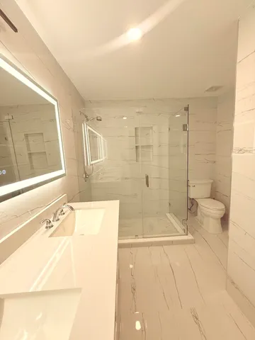 a bathroom with a bathtub and a shower