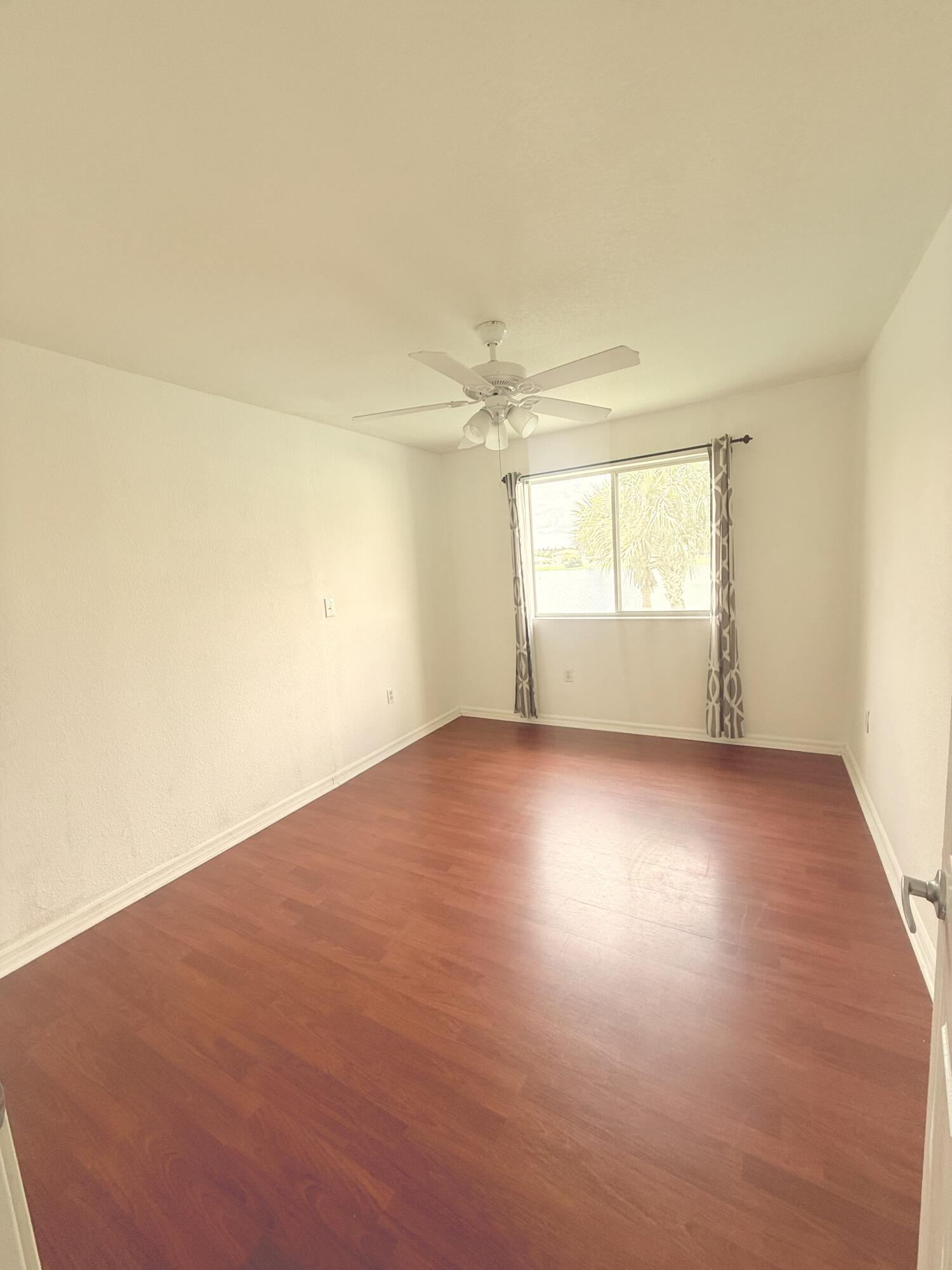 4534 Southwest 127th Terrace Miramar, FL 33027 - Photo 37 of 45 an empty room with wooden floor and windows