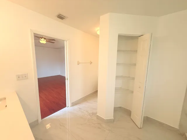 a view of a hallway with closet